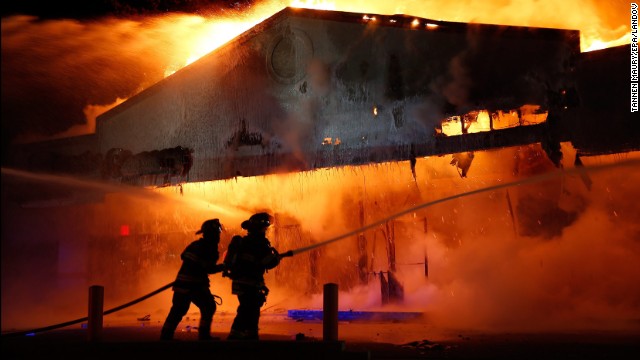 Firefighters work on extinguishing a Little Caesars restaurant on November 24.