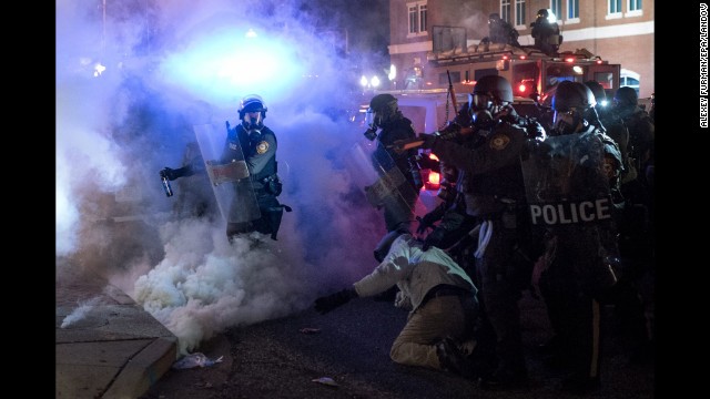 Riot police clash with protesters on November 24.