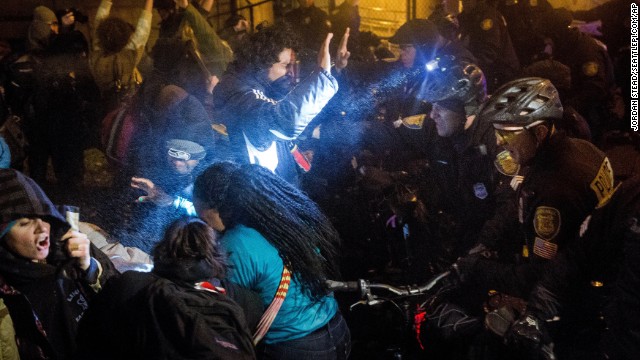Seattle police attempt to push back protesters with pepper spray and flash-bang grenades on November 24.