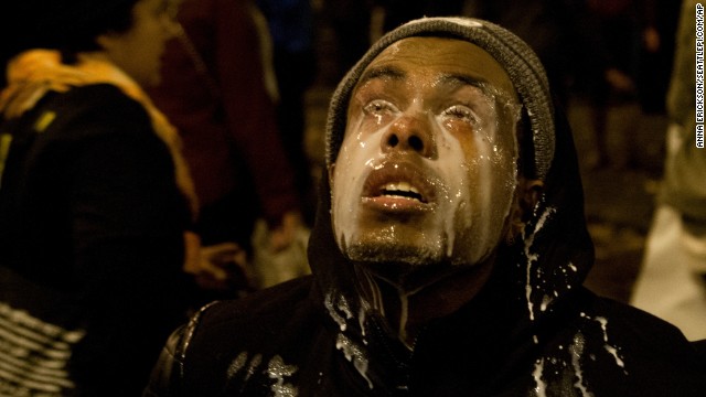 A Seattle protester pours milk in his eyes after being tear-gassed on November 24.