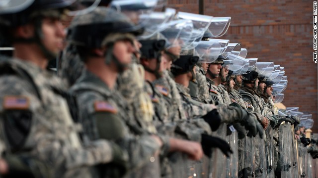 National Guard troops secure the police station in Ferguson on November 25.