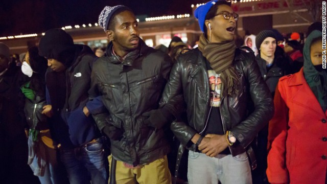 Protesters link arms in front of the Ferguson Police Department on November 25.