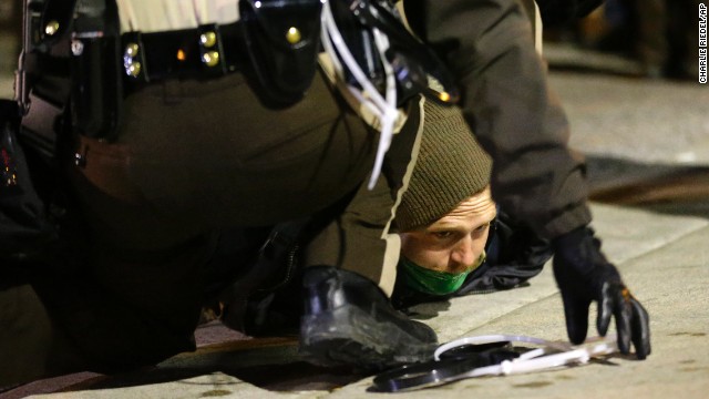 Police take a protester into custody on November 25.