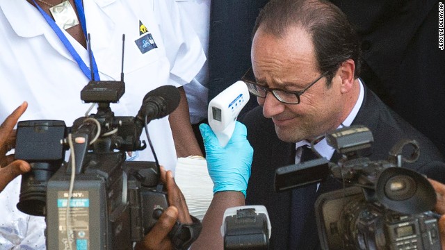 French President Francois Hollande has his temperature taken as he arrives at the Donka hospital in Conakry, Guinea, on Friday, November 28.