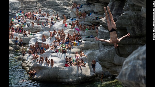 Liam Atkins dives from 20 meters (65.6 feet) as spectators in Ponte Brolla, Switzerland, watch him compete in the International Cliff Diving Championship on Saturday, July 19. The Australian finished fourth in the men's competition, which was won by Russia's Ilya Shchurov.