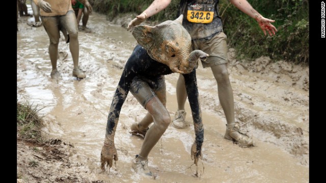 A Mud Day participant wearing an elephant mask competes in Beynes, France, on Thursday, May 8. The eight-mile course had more than 20 obstacles, most of them set in mud.