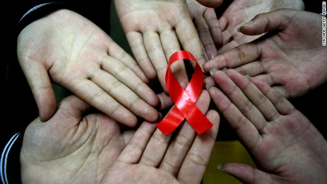 File photo: Chinese students show a handmade red ribbon one day ahead of World AIDS Day, at a school in east China's Anhui province on November 30, 2009. 