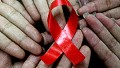 Chinese students show a handmade red ribbon one day ahead of the the World AIDS Day, at a school in Hanshan, east China's Anhui province on November 30, 2009. 