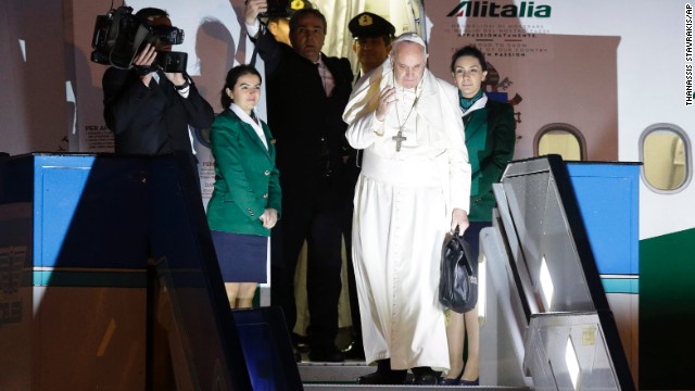 Pope Francis waves as he boards a plane for Rome at the Istanbul Ataturk airport on Sunday, November 30, concluding his three day visit the the predominantly Muslim country. 