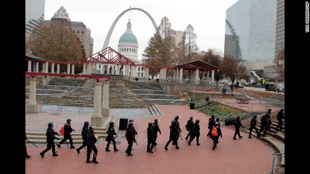 Officers wearing riot gear walk through a park in downtown St. Louis on November 30.