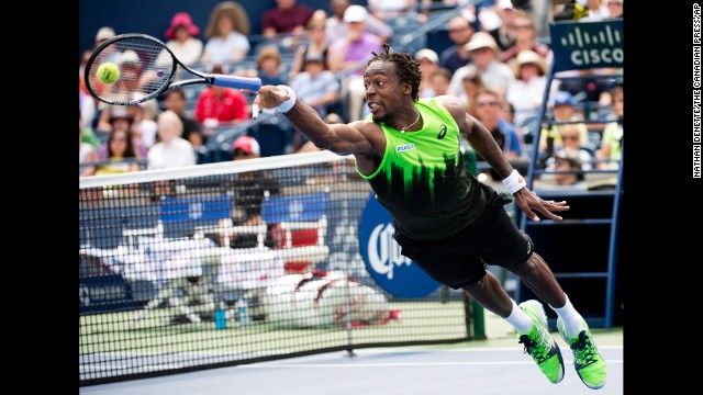Gael Monfils loses his racket as he dives for the ball during his Rogers Cup match against Novak Djokovic on Wednesday, August 6, in Toronto. Djokovic won the second-round match in three sets.