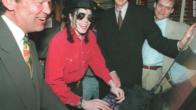 Pop superstar Michael Jackson plays Sony's then-new PlayStation in May 1995 as Sony Corp of America CEO Michael Schulhof, left, and Phil Harrison of Sony Computer Entertainment-Europe look on. This photo was taken at the Electronic Entertainment Expo in Los Angeles.