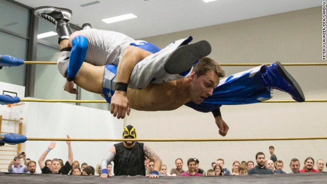 Pro wrestler Maik Tuga, bottom, fights Nacho Libres during a Swiss Championship Wrestling event held Saturday, May 31, in Zollikofen, Switzerland.