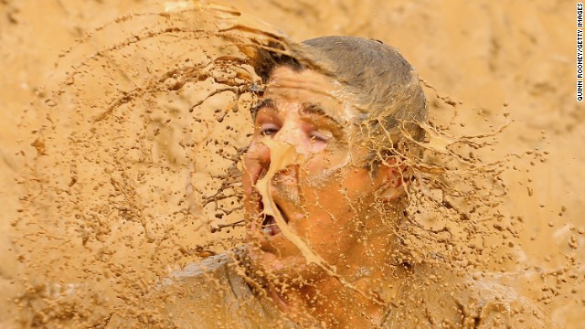 A competitor falls into muddy water during the Tough Mudder obstacle race held Saturday, March 22, in Phillip Island, Australia.