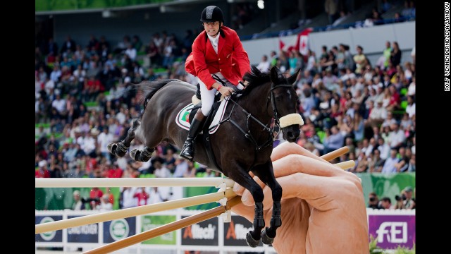 Norbert Ell clears a hurdle with his horse T-Quinta during the World Equestrian Games on Wednesday, September 3.