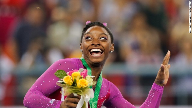 American gymnast Simone Biles ducks from a bee Friday, October 10, during a medal ceremony at the World Gymnastics Championships in Nanning, China. Biles had just won gold in the individual all-around. When the entire competition wrapped up a couple of days later, Biles had won four golds in all. She also finished first in the balance beam and the floor exercise, and the United States was victorious in the team event.