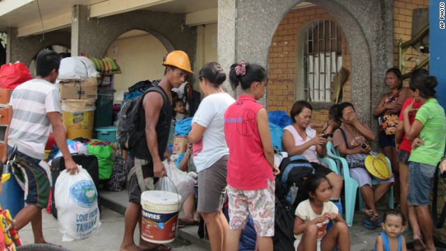 Residents arrive at an evacuation center in Tacloban city, Leyte province, central Philippines Thursday, Dec. 4, 2014, as they prepare for approaching Typhoon Hagupit.