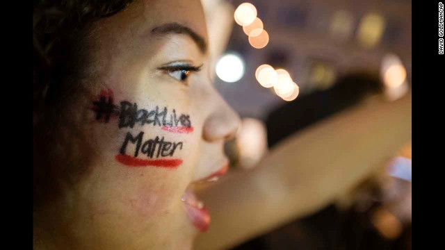 "Black Lives Matter" is written across the cheek of Samaria Muhammad as she chants with fellow protesters in Atlanta on December 4. 