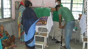 Medical staff use a bicycle pump to inflate a patient\'s abdomen during surgery.