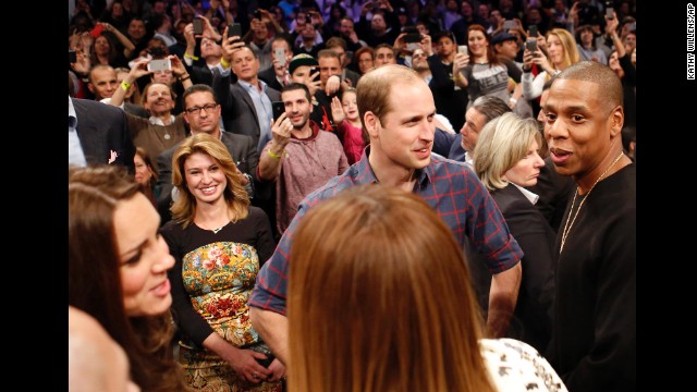 Prince William talks with rapper Jay-Z as Kate chats with singer Beyonce after the basketball game.