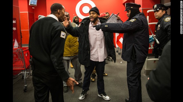 Police clash with demonstrators at the entrance of a Target near the Barclays Center on December 8.
