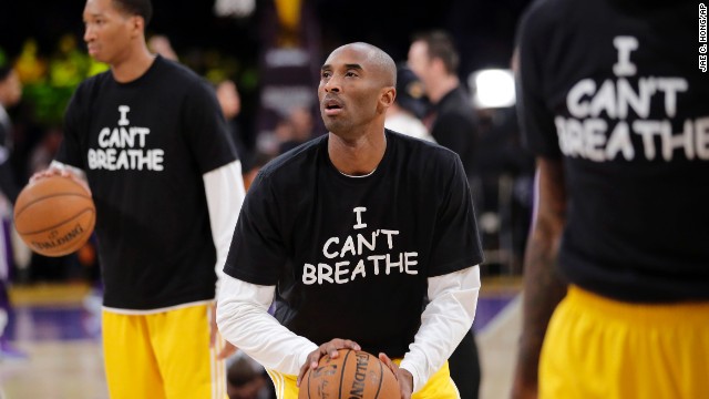 Los Angeles Lakers' Kobe Bryant, center, warms up before an NBA basketball game against the Sacramento Kings on Tuesday, December 9, in Los Angeles. The team wore "I Can't Breathe" shirts during warm-ups in support of the family of Eric Garner. Since a grand jury declined to indict a New York police officer in the death of Garner, demonstrators across the country have taken to the streets to express their outrage. Garner, a 43-year-old asthmatic, died in July after he was put in a chokehold by the officer, Daniel Pantaleo.