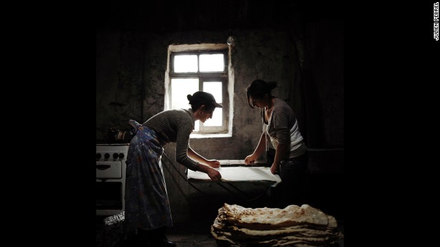 Anoush and Ruzanna, two sisters-in-law, prepare bread in the Armenian village of Lichk. Their husbands and brothers, like almost all of the village's working-age men, work in Russia for most of the year.