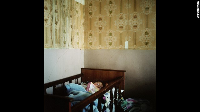 Lilith, Anoush's daughter, fell asleep with her father's photo album. He went to Russia to earn money so they could build a house in the village.