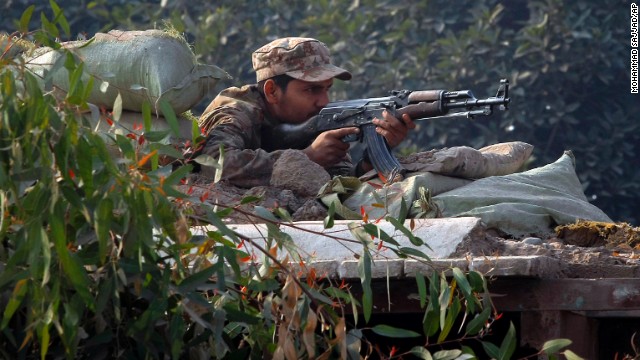 A Pakistani soldier takes position on a bunker close to the besieged school.