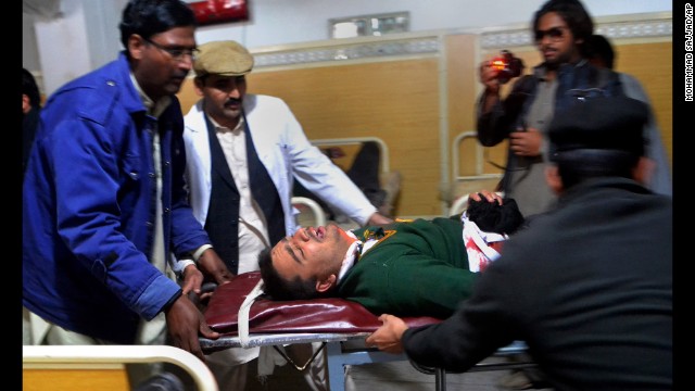 Hospital staff transport an injured student in Peshawar on December 16.