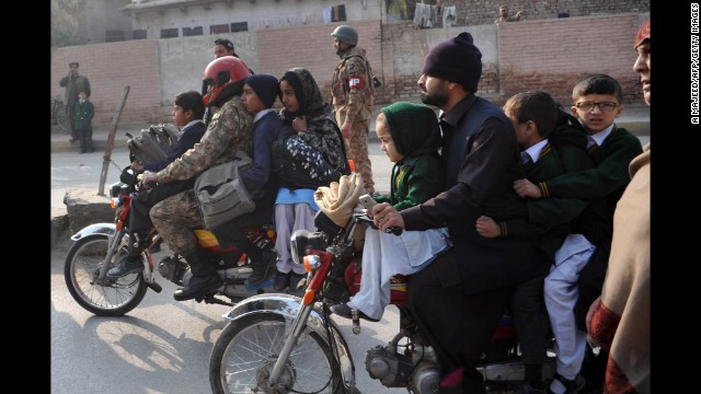 Parents leave with their children near the site of the attack.