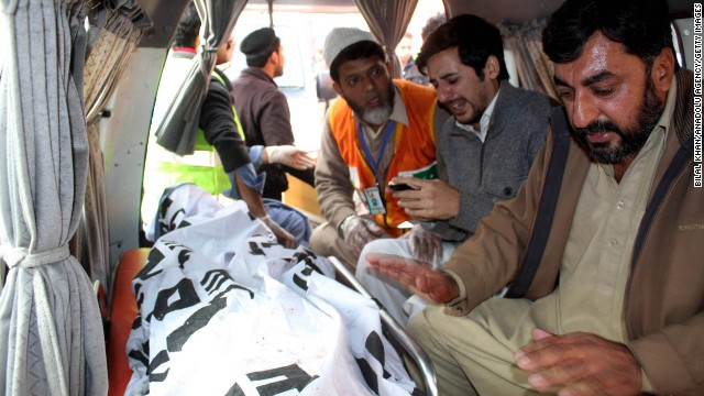 Relatives of a student killed in the attack mourn over the body in Peshawar on December 16.
