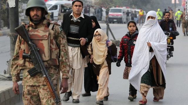 Parents escort their children away from the school.