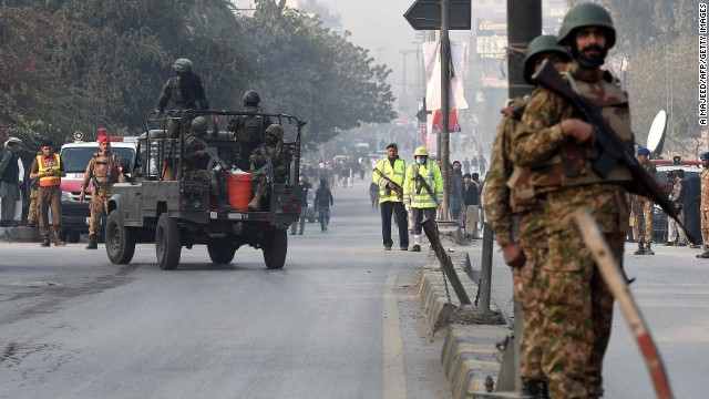 Pakistani soldiers take position near the site of the school attack in Peshawar on December 16. All the militants in the attack were later killed, a police official said.