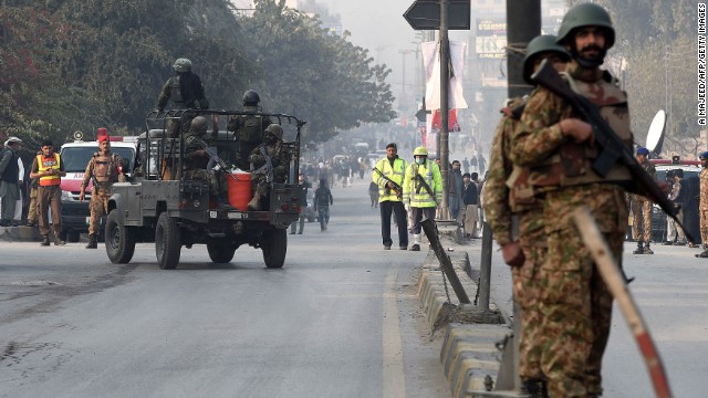 Pakistani soldiers take position near the site of the attack.