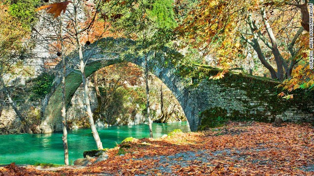 Scenic mountain roads and arched stone bridges connect villages filled with guesthouses and cafes around the Aristi Mountains.