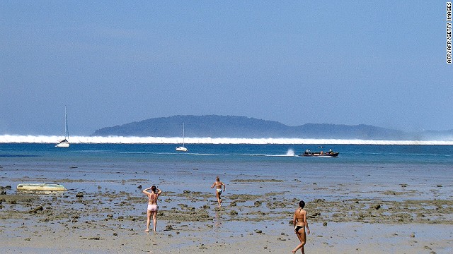 Foreign tourists react as the first of six tsunami start to roll towards Hat Rai Lay Beach, near Krabi in southern Thailand on December 26, 2004. The 2004 Indian Ocean tsunami caused massive destruction along coastal areas of 14 countries, including Thailand, India, Sri Lanka, Indonesia and Malaysia.