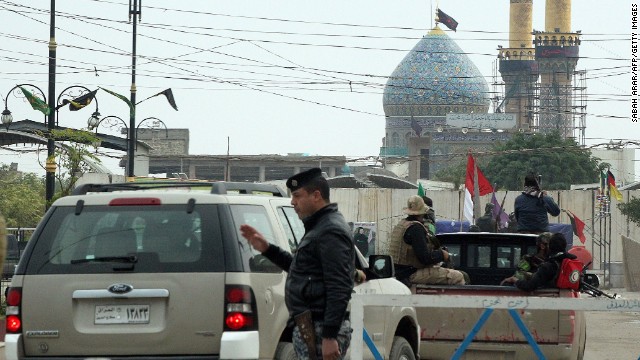 Pro-Iraqi government forces guard a shrine in Balad, Iraq, on Monday, December 15.