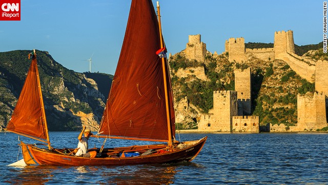 <strong>Golubac Fortress</strong>: Dragan Miletic took this photo of a colorful boat on the river Danube, with the medieval <a href='http://ireport.cnn.com/docs/DOC-1191741'>Golubac fortress</a> bathed in golden light in the background. 