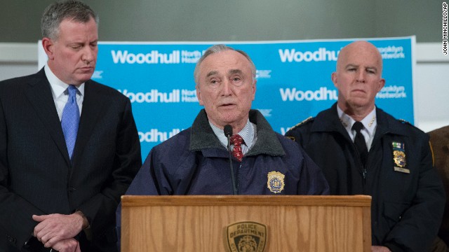 New York Police Department Commissioner Bill Bratton speaks alongside Mayor Bill de Blasio, left, and NYPD's Chief of Department James O'Neill, right, during a news conference at Woodhull Medical Center on December 20. 