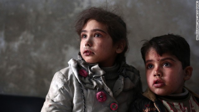 Syrian children await medical treatment at a makeshift clinic in the besieged rebel town of Douma, on Sunday, December 21, near Damascus.