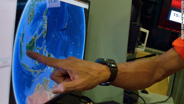 An official from Indonesia's national search and rescue agency points to the position where AirAsia Flight QZ8501 went missing. Before communication was lost, a pilot asked to deviate from its planned route -- from the Indonesian city of Surabaya to Singapore -- because of bad weather, officials said.