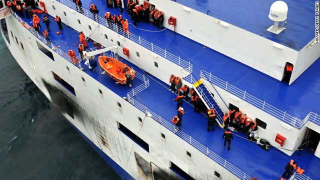 Passengers wait to be rescued from onboard the burning ferry.