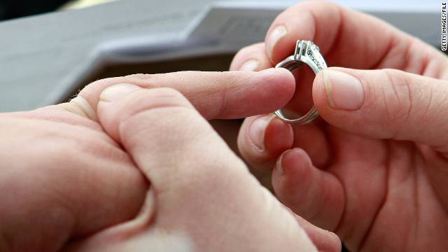 Jodie Vandermark-Martinez slides a ring on her partner Jessice during their wedding ceremony in Iowa.