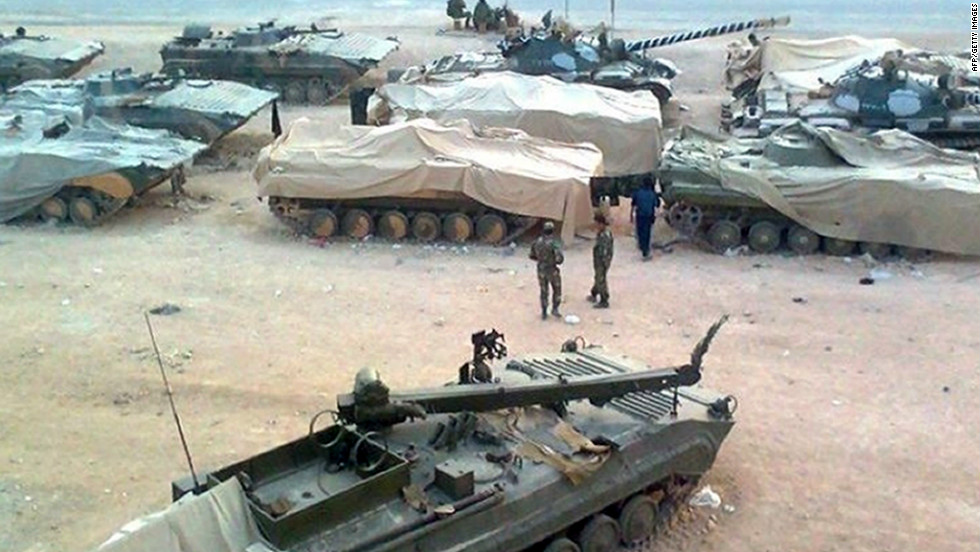 A  picture released by the Local Coordination Committees in Syria shows troops taking position in Homs on January 19, 2012 .