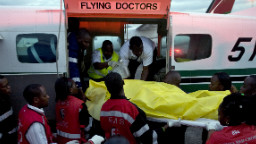 A victim of one of the attacks on churches in the Kenyan town of Garissa, near the border with Somalia, is wheeled by paramedics on July 1, 2012 to a waiting ambulance after she was airlifted to Nairobi.