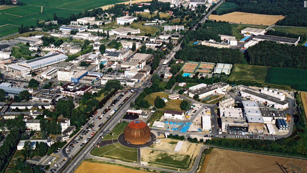 CERN's Globe of Science and Innovation exhibition centre and the nearby Meyrin site are seen from the air. The surface buildings which provide access and support for the ATLAS experiment, one of four experiments on the LHC, can also be seen on the right.