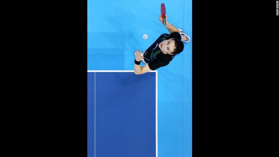 Aleksandra Privalova of Belarus serves against Xing Han of Congo during their women's singles table tennis match.