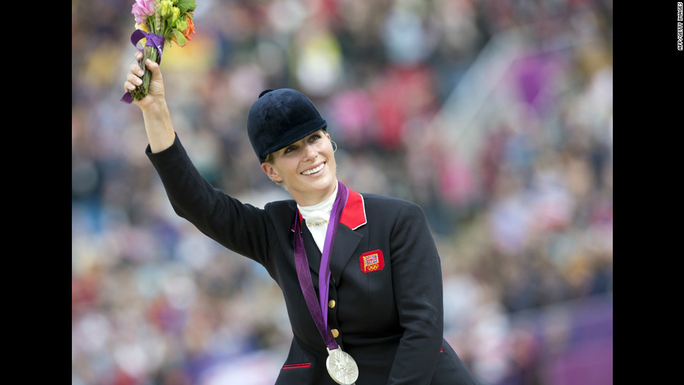 Britain's Zara Phillips waves to the crowd after the British equestrian team won the silver medal in eventing. As part of the British team, Phillips, Queen Elizabeth II's granddaughter, becomes the first member of Britain's royal family to take home an Olympic medal.