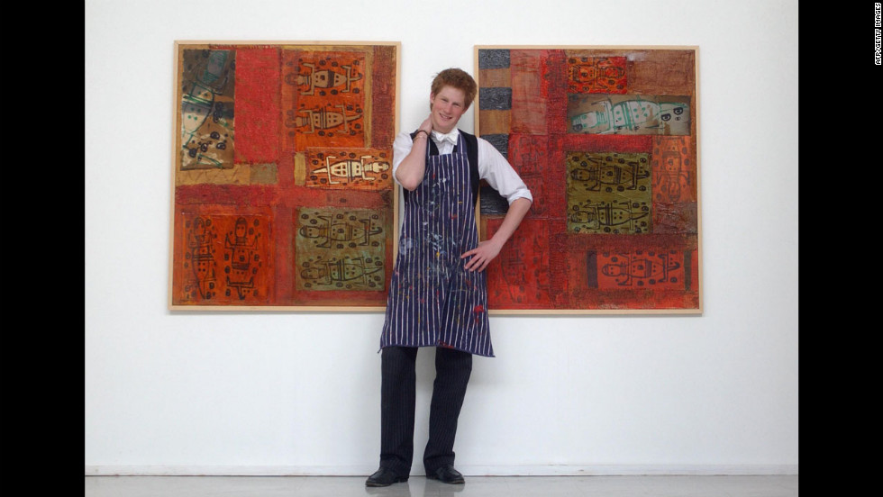 Prince Harry stands in the Drawing School on May 12, 2003, between two of the works he completed while studying at Eton College. His work involves a mixture of painting and printing, and reflects his habit of using animals as his starting point.